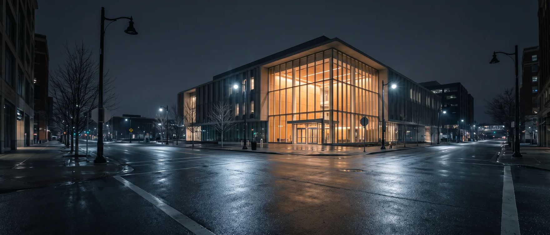 Quiet street at night outside a county jail lobby where families come for an inmate search